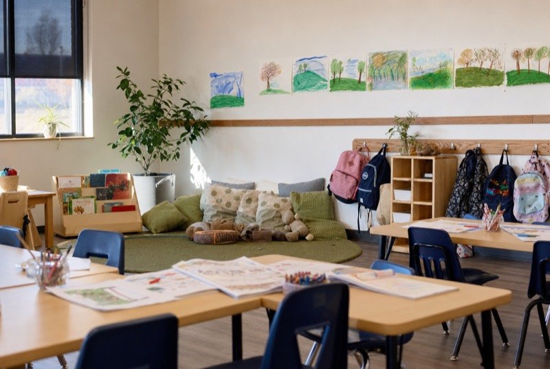 A bright children&rsquo;s learning room with workbooks and a reading corner